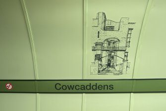 Detail view of the signage and mural on the tunnel walls of Cowcaddens subway station
