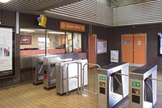 View of the ticket office and barriers within the concourse of Cowcaddens subway station