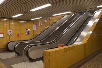 View of escalators and stair within the stair hall of St George’s Cross subway station