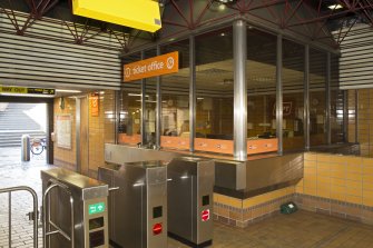 View of ticket office and turnstiles within the concourse of St George’s Cross subway station