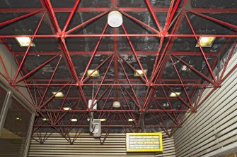 View looking up into the exposed structure of the concourse roofspace within St George’s Cross subway station