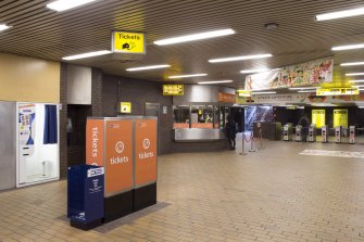 View looking across the concourse of Buchanan Street subway station, including ticket machines, office and turnstiles