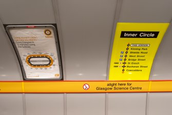 Detail view of signage and network maps on the tunnel wall of Cessnock subway station