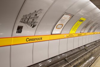 Detail view of mural and signage on the tunnel wall of Cessnock subway station