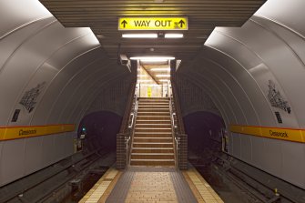 View taken from platform level, of main stair linking platform and concourse levels of Cessnock subway station, with flanking tunnel openings
