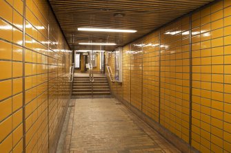 View looking along tiled corridor linking platform and concourse levels of Cessnock subway station