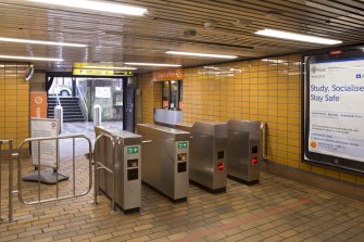 View looking back across the concourse of Cessnock subway station, showing turnstiles, ticket office and main entrance