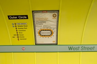 Detail view of signage and network maps on the tunnel wall of West Street subway station