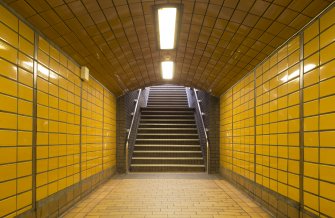 View looking along tiled corridor to main stair up to concourse level of West Street subway station