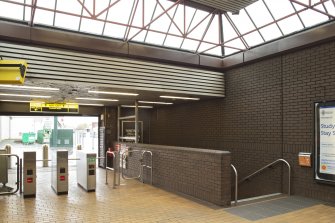 View looking across concourse of West Street subway station to turnstiles and stair leading to platforms