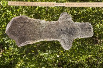 View of cruciform cross (2), situated in burial ground to north of church (flash, including scale)
