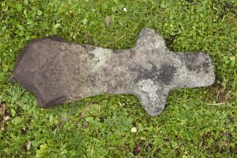 View of cruciform cross (2), situated in burial ground to north of church (daylight)