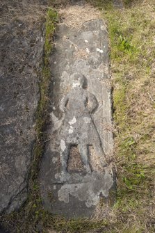 Detail of gravestone with carved effigy.