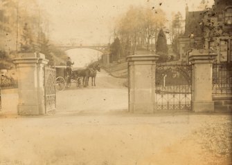 General view of gateway with coach and horses.
