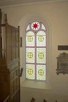Interior. Detail of stained glass window to west of pulpit