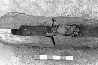 The eroded sectioned breech end of an iron gun, after cleaning. A quadrant of metal has been cut from the breech end to reveal the chamber profile (1974). The iron ball is in place, as is the hemp wadding on either side of it. Scale in inches.