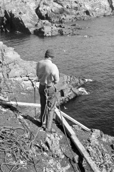 The cliff-top tender paying out the air-hose over our improvised gantry (1977). The operator was always roped for safety.