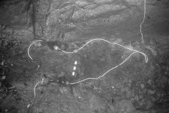 An area of concretion at the bottom of the main gulley, prepared for treatment with explosives. At top right a thin electrical wire will carry an electrical charge from the surface, activating a detonator secured to the looped detonating cord. This will pass detonation along each of the separate runs of cord along which very small charges have been placed. The effect of this treatment was to render the concretion loose enough for excavation without displacing the contexts of items within it (1977).