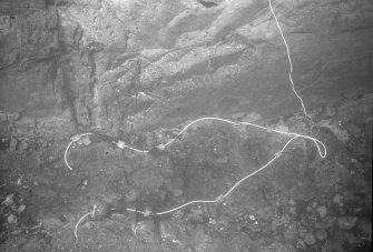 An area of concretion at the bottom of the main gulley, prepared for treatment with explosives. At top right a thin electrical wire will carry an electrical charge from the surface, activating a detonator secured to the looped detonating cord. This will pass detonation along each of the separate runs of cord along which very small charges have been placed. The effect of this treatment was to render the concretion loose enough for excavation without displacing the contexts of items within it (1977).