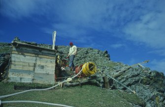 Tony Long tending the compressors at the cliff-top base (1977).