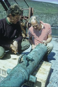 Chris Oldfield and Sydney Wignall examine the bronze media sacre after recovery (1970).