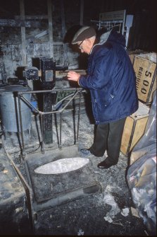 Andrew Williamson, curator of the Shetland Museum, weighing one of the lead ingots (1986).