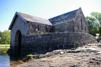 Achranich boathouse from the south-south-west, showing the retaining wall for the raised ground in the angle of the main boathouse and the south wing,  a sheltered and sunny area. (Paula Martin)