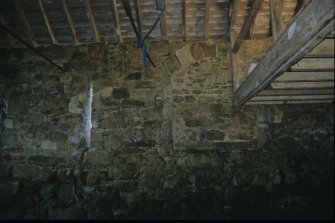 Interior of the north wall, Achranich boathouse, showing the central blocked -in arched opening. The main loft floor beam (right) is set into the blocking, showing it to be a later insertion.