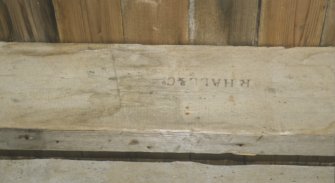 Stamped mark on the side of a joist supporting the loft floor 'R HALL 					& Co', Achranich boathouse.