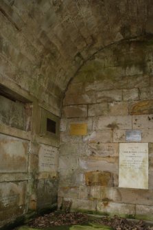 View into west corner of the Cambo estate mausoleum, showing the back wall and full height of the stone vault.