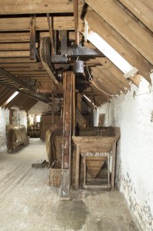 Interior View of mill workings, including grain elevator and hopper, at second floor level of mill.