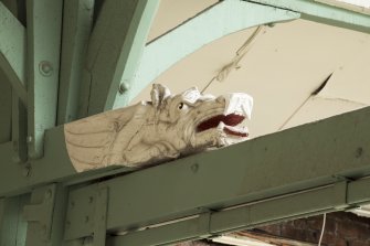 Interior. Detail of wolf-dragon headed carved bracket on structural stantion, Alloa Public Baths and Gymnasium.