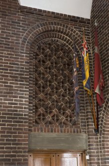 Interior. Latticed brick archway above doorway at west end of north aisle