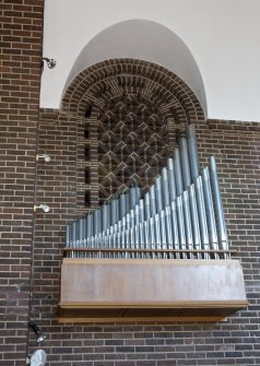 Interior. Organ pipes and latticed brick archway