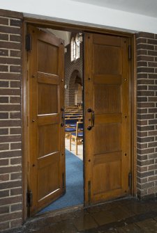Interior. Entrance lobby, view of double doors leading into church