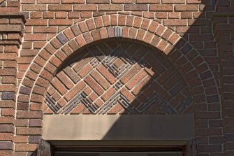 South entrance, detail of brick arched pediment