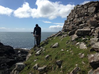 G Cavers (AOC) surveying the outer face of the outer wall.