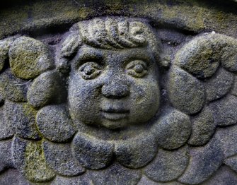 Detail of relief showing the face and wings of an angel, the Howff Burial Ground, Dundee.