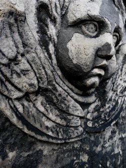 Detail of relief showing face and wings of angel, Old Calton Burial Ground, Edinburgh.