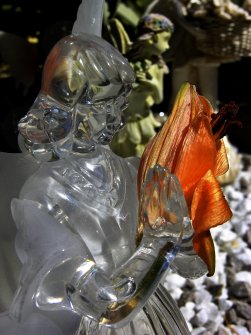 Detail of a glass statue of an angel holding a flower, Rosebank Cemetery, Edinburgh.