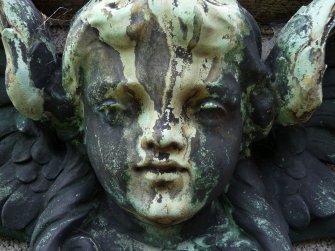 Detail of relief showing the head of an angel, covered in cobwebs, The Grange Cemetery, Edinburgh.