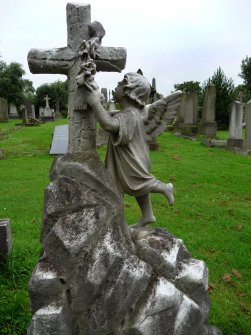 Image showing a statue of an angel placing a garland of flowers on a cross. The Grange Cemetery, Edinburgh.