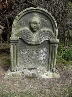 Detail of headstone showing the head and wings of an angel, in memory of Euphan Davidson, c.1716. Currie Kirk Cemetery, Edinburgh.