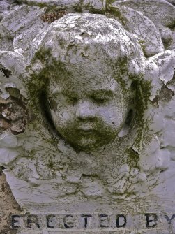 Detail of relief showing the head and wings of an angel, the Cathedral Graveyard, St. Andrews.