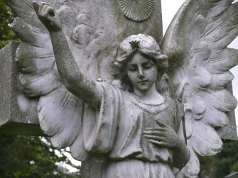 Image of angel pointing towards the heavens, with cross behind, Cathedral Graveyard, St. Andrews.