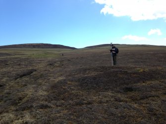 General shot of new burnt being surveyed, with Knowe of Dale behind.