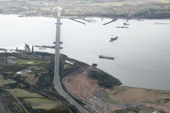 Oblique aerial view during construction of the New Forth Bridge Crossing, looking to the S.