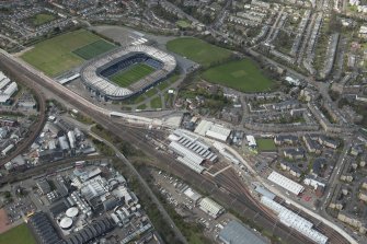 Oblique aerial view of Haymarket Motive Depot with new Edinburgh Tramway adjacent, looking to the NNW.