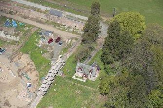 Oblique aerial view of Dumfries House Garden Cottage during construction works, looking to the NNW.