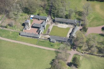 Oblique aerial view of Hardington House Stable Range, looking to the E.